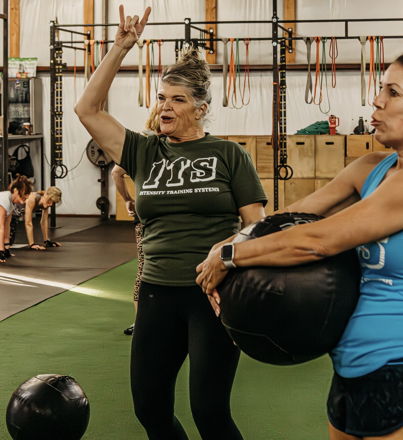 An ITS coach cueing a member through a medicine ball movement
